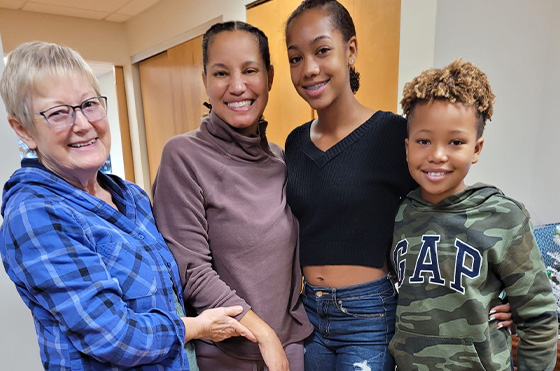 Clara and Erina pose for a picture with Erina’s kids, Macie and Cole.
